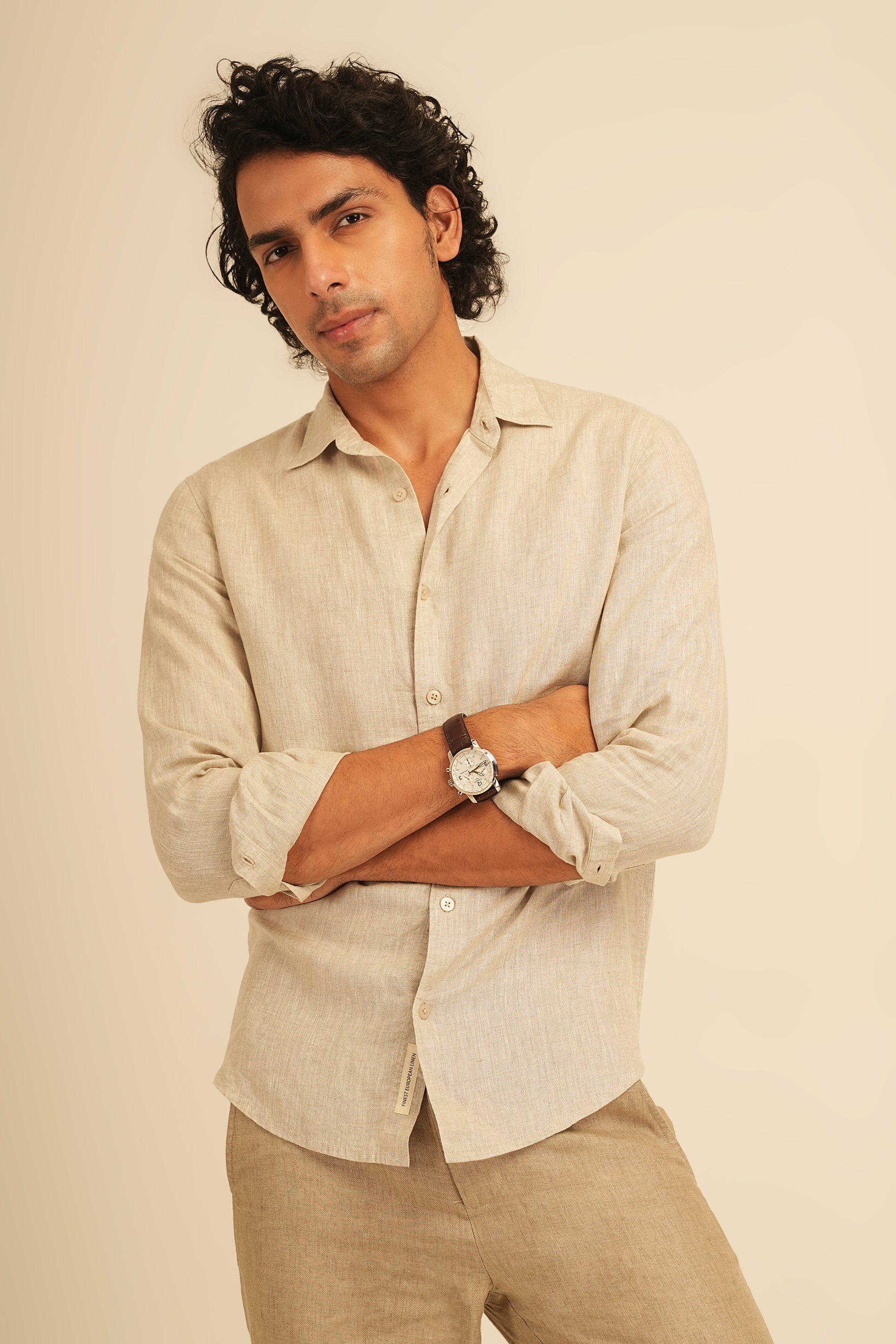 Man wearing a 100% European Linen shirt, the highest quality of pure linen in the world. Available at an accessible price point which is less than half that of traditional brands. The shirt is has a regular fit for everyday wearing. Works well in office, and out. Perfect for vacations due to the fabric's high breathability and light weight.